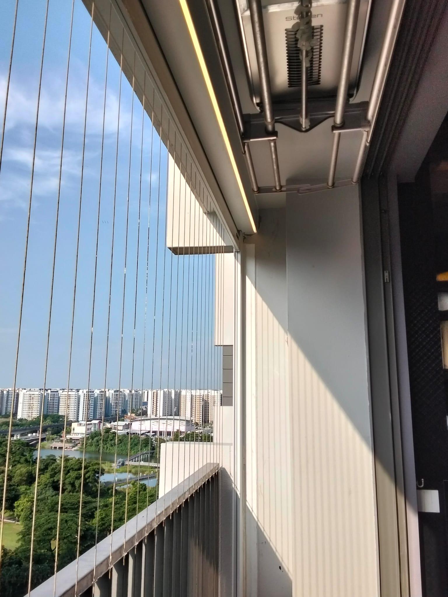 High-rise condo balcony showing an outdoor blind headbox, invisible grille and existing ceiling fixtures