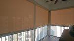 Condo balcony with SmartZip outdoor Zipblind panels installed across a corner opening in Singapore