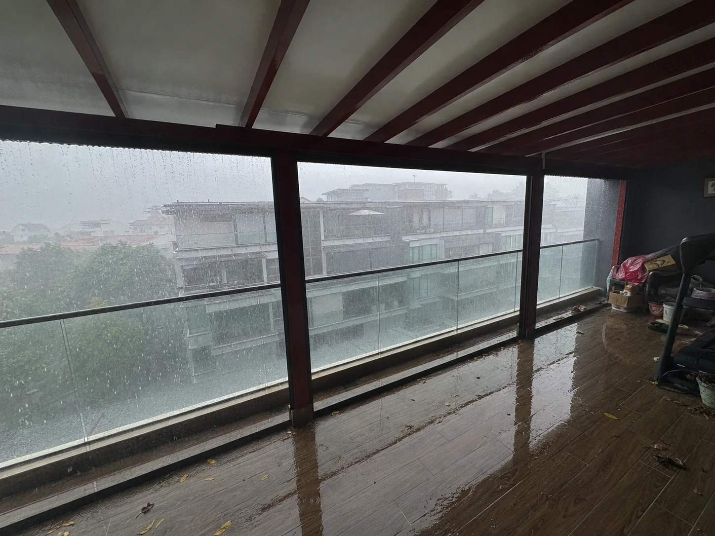 Open balcony exposed to heavy rain with water entering the floor area