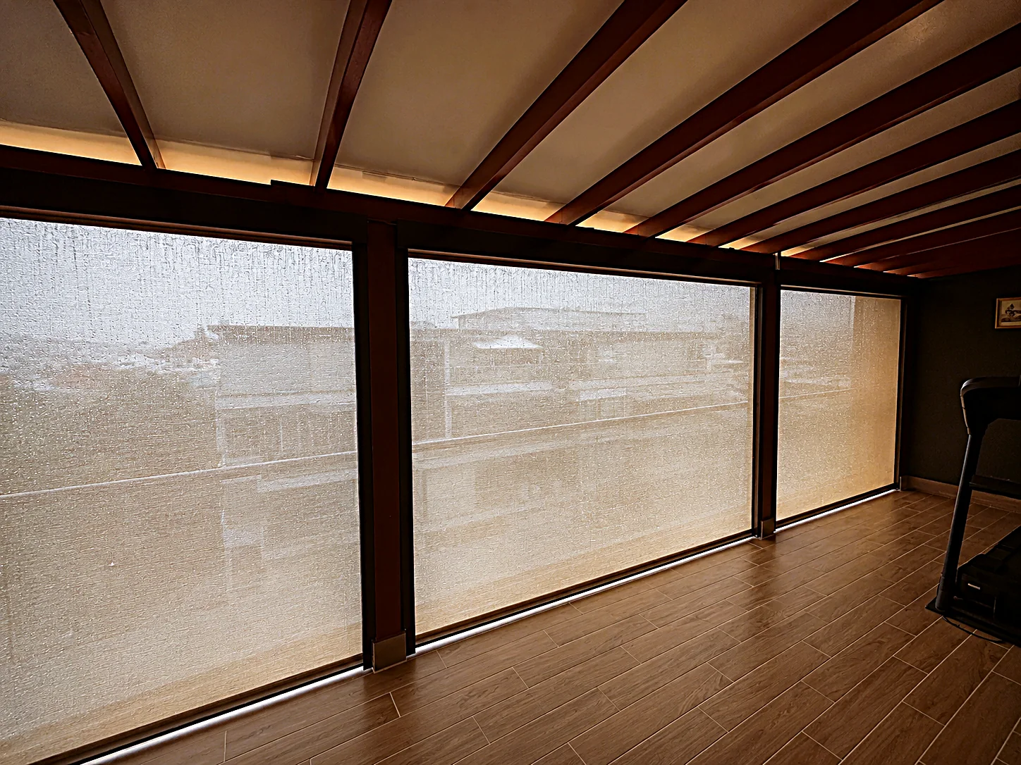 SmartZip outdoor blinds lowered during rain on a covered balcony in Singapore
